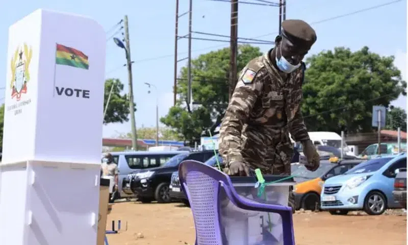 A security officer casting his ballot