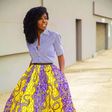 African woman rocking midi skirt and shirt