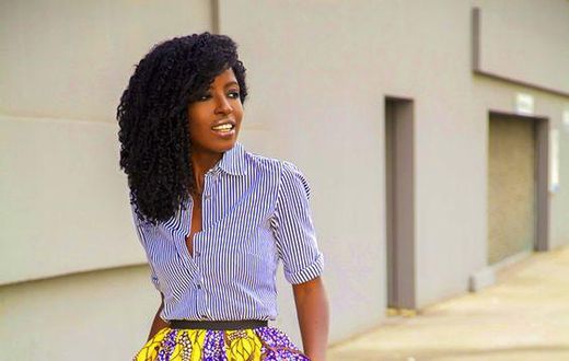 African woman rocking midi skirt and shirt