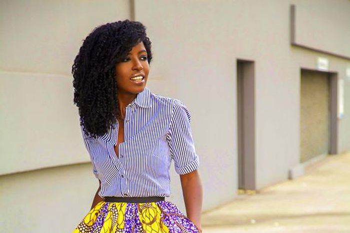 African woman rocking midi skirt and shirt