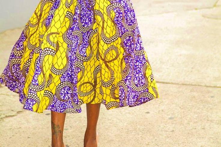 African woman rocking midi skirt and shirt