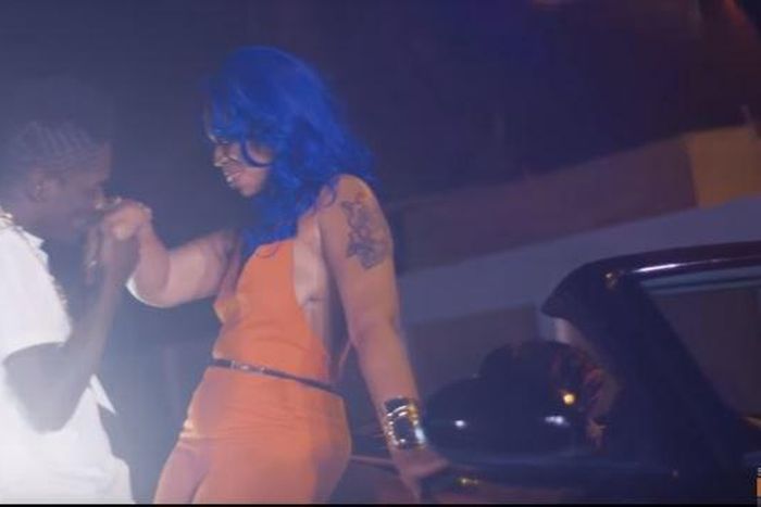 Shatta Wale kisses his baby mama's hands in "Chop Kiss" music video