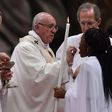 Pope Francis gives holy communion during the Easter vigil at St Peter’s basilica in the Vatican.Photograph: Alberto Pizzoli/AFP/Getty Images