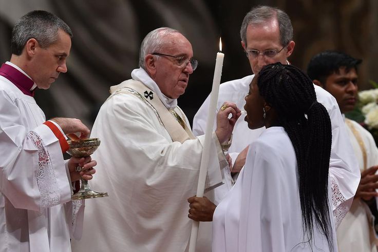Pope Francis gives holy communion during the Easter vigil at St Peter’s basilica in the Vatican.Photograph: Alberto Pizzoli/AFP/Getty Images