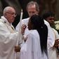 Pope Francis gives holy communion during the Easter vigil at St Peter’s basilica in the Vatican.Photograph: Alberto Pizzoli/AFP/Getty Images