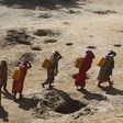 Women carry jerry cans of water from shallow wells dug from the sand along the Shabelle River bed, which is dry due to drought in Somalia's Shabelle region, March 19, 2016. REUTERS/Feisal Omar
