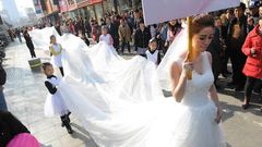 Woman models longest wedding dress ever