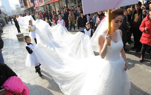 Woman models longest wedding dress ever