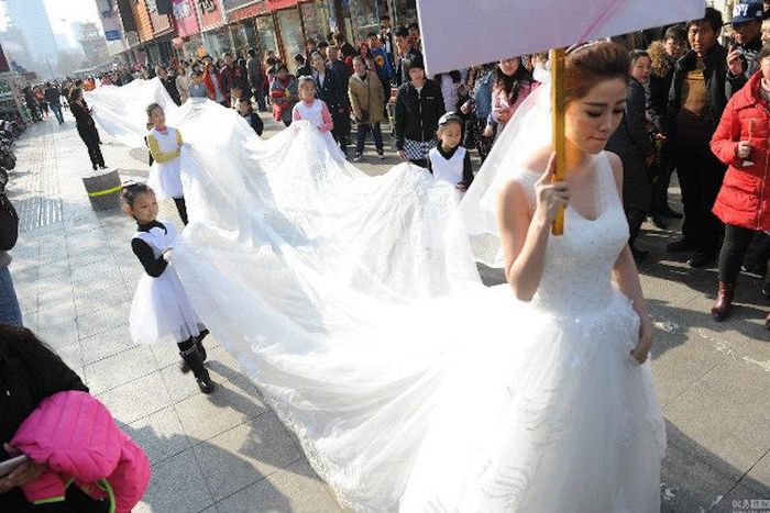 Woman models longest wedding dress ever