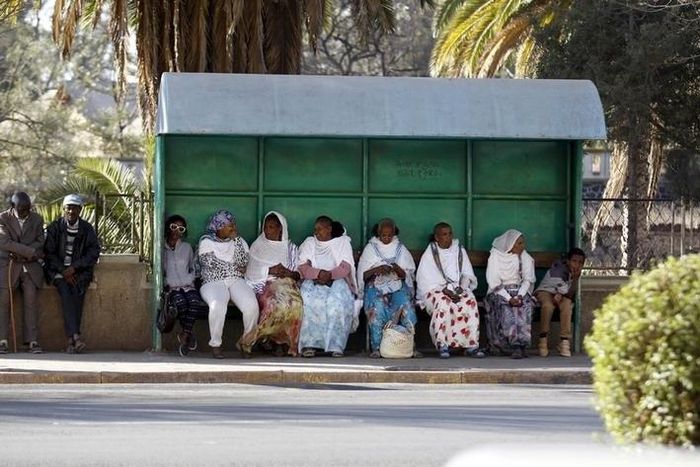Passangers wait for public transport at a bus-stop in Eritrea's capital Asmara, February 20, 2016. ERITREA-POLITICS/ REUTERS/Thomas Mukoya
