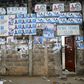 Election posters are seen pasted on a wall at the entrance to Benin Tennis Club, a day before the presidential election in Cotonou, March 5, 2016. REUTERS/Akintunde Akinleye