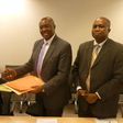 Henry Kerali, World Bank Country Director for Ghana  exchanging signed agreement with  Patrick Awuah, President of Ashesi, looking on is Mr Fredua Agyeman, Director of Environment, Ministry of Environment, Science, Technology and Innovation Climate