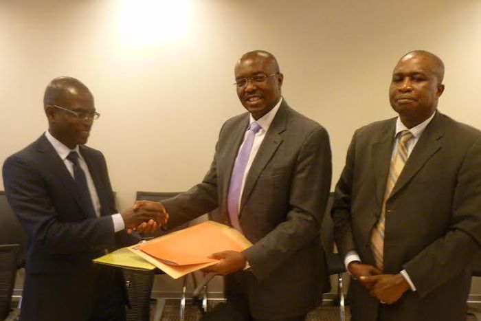 Henry Kerali, World Bank Country Director for Ghana  exchanging signed agreement with  Patrick Awuah, President of Ashesi, looking on is Mr Fredua Agyeman, Director of Environment, Ministry of Environment, Science, Technology and Innovation Climate