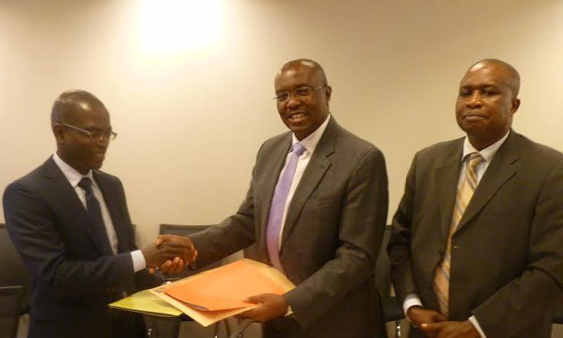 Henry Kerali, World Bank Country Director for Ghana  exchanging signed agreement with  Patrick Awuah, President of Ashesi, looking on is Mr Fredua Agyeman, Director of Environment, Ministry of Environment, Science, Technology and Innovation Climate