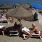 Tourists sunbathe on a beach in Fuengirola, on Costa del Sol, southern Spain, July 12, 2015.