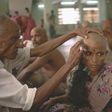 A devotee gets her head tonsured at the temple of Tirumala in Andhra Pradesh. The hair is collected, sorted, resold and then used in wigs and hair extensions.