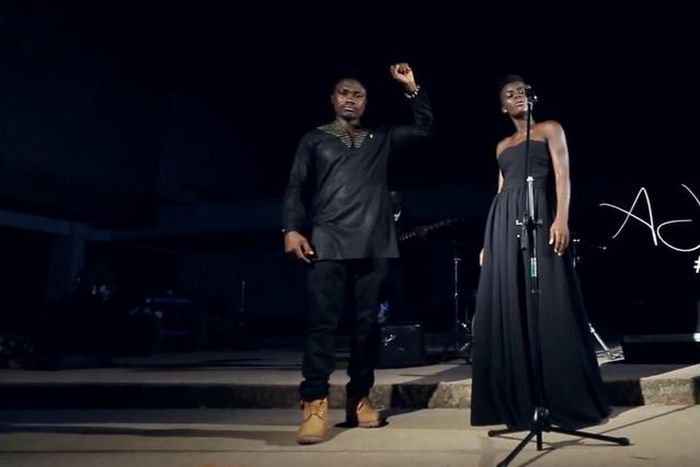 AJ Nelson and Wiyaala garbed in all black African prints performing in "Power To The People" music video