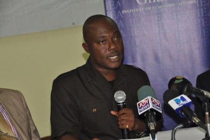 Dr Ransford Gyampo holding a microphone