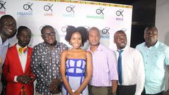 Okyeame and MzVee take group photos with management at "Small Small" video premiere at Grand Papaz