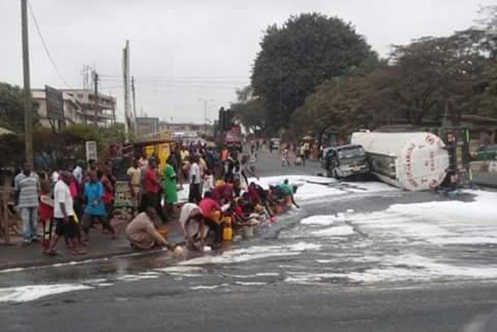 Residents scooping fuel as tanker overturns