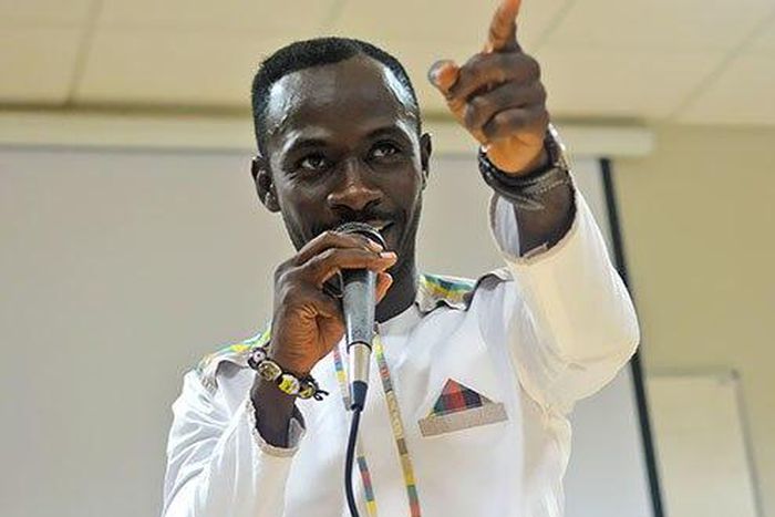 Okyeame Kwame with a microphone