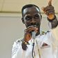 Okyeame Kwame with a microphone