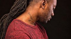 Pappy Kojo with a tattoo