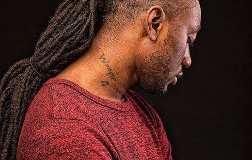 Pappy Kojo with a tattoo