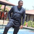 John Dumelo standing by a pool