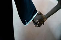 An 11-year-old rape survivor holds his mother’s hand after visiting a psychologist and social worker who are helping him deal with the trauma of rape. Tess Ingram/UNICEF