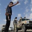 Members of the pro-government Popular Committees militia man a checkpoint at an entrance of Yemen"s southern port city of Aden December 3, 2015.