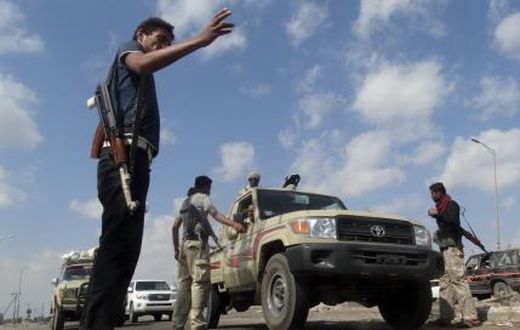 Members of the pro-government Popular Committees militia man a checkpoint at an entrance of Yemen"s southern port city of Aden December 3, 2015.