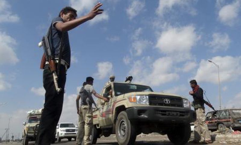 Members of the pro-government Popular Committees militia man a checkpoint at an entrance of Yemen"s southern port city of Aden December 3, 2015.