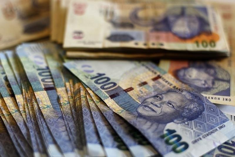 South African bank notes featuring an image of former South African President Nelson Mandela are displayed at an office in Johannesburg January 17, 2013. REUTERS/Siphiwe Sibeko