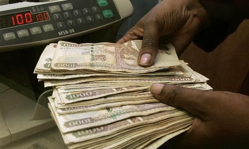 A currency dealer counts Kenya shillings at a money exchange counter in Nairobi  in a file photo.   REUTERS/Antony Njuguna