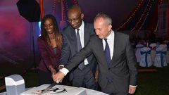 Momar Nguer (centre), Total's Africa and Middle East Senior Vice President, former Total Kenya managing director Ms Ada Eze (left) and Total Kenya chairman Jean-Christian Bergeron cut a cake to celebrate the firms 60th anniversary.