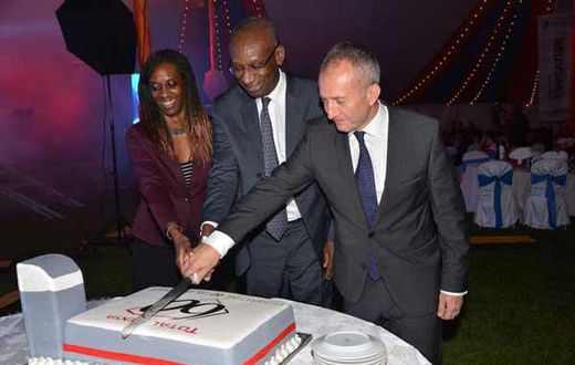 Momar Nguer (centre), Total's Africa and Middle East Senior Vice President, former Total Kenya managing director Ms Ada Eze (left) and Total Kenya chairman Jean-Christian Bergeron cut a cake to celebrate the firms 60th anniversary.