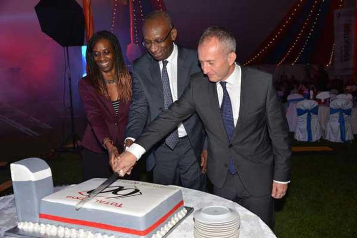 Momar Nguer (centre), Total's Africa and Middle East Senior Vice President, former Total Kenya managing director Ms Ada Eze (left) and Total Kenya chairman Jean-Christian Bergeron cut a cake to celebrate the firms 60th anniversary.
