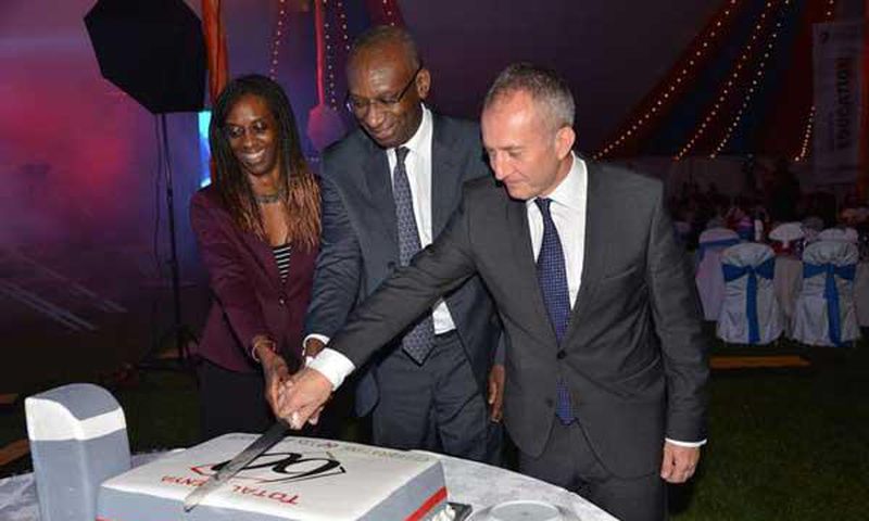 Momar Nguer (centre), Total's Africa and Middle East Senior Vice President, former Total Kenya managing director Ms Ada Eze (left) and Total Kenya chairman Jean-Christian Bergeron cut a cake to celebrate the firms 60th anniversary.