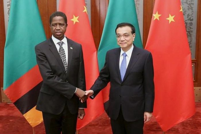 Chinese Premier Li Keqiang (R) shakes hands with Zambia's President Edgar Chagwa Lungu at the Great Hall of the People in Beijing March 30, 2015. REUTERS/Feng Li/Pool