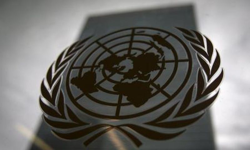 The United Nations headquarters building is pictured though a window with the UN logo in the foreground in the Manhattan borough of New York August 15, 2014.