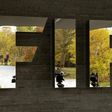 Journalists are reflected in FIFA's logo as they wait during an extraordinary meeting of the FIFA Executive Committee in front of FIFA's headquarters in Zurich, Switzerland October 20, 2015. REUTERS/Arnd Wiegmann