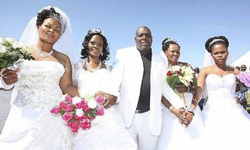 A happy groom with his brides