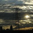 Electricity pylons in Johannesburg's Alexandra township stand against the skyline of the city's Sandton business district in this file photo. REUTERS/Mike Hutchings/Files