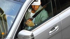 Lewis Hamilton driving and playing with his phone