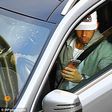 Lewis Hamilton driving and playing with his phone