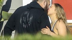 Ronda Rousey and boyfriend, Travis Browne kiss during a walk