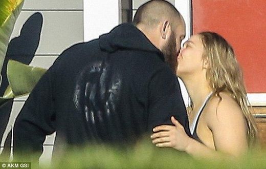 Ronda Rousey and boyfriend, Travis Browne kiss during a walk