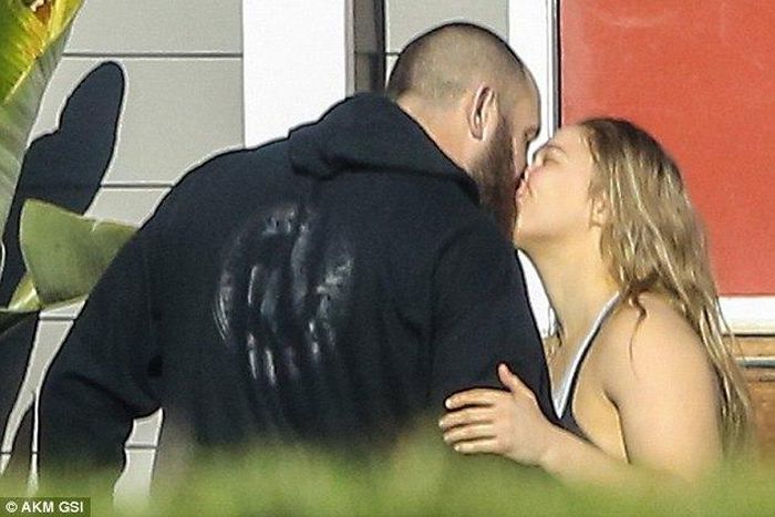 Ronda Rousey and boyfriend, Travis Browne kiss during a walk