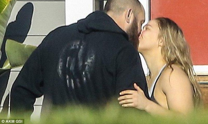 Ronda Rousey and boyfriend, Travis Browne kiss during a walk